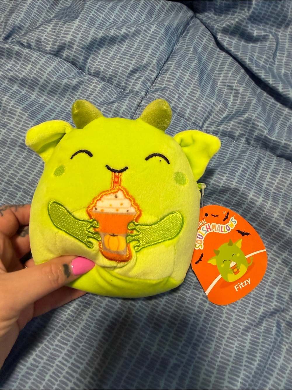 Squishmallow Halloween Squad Fitzy the Goblin plush toy holding a pumpkin spice